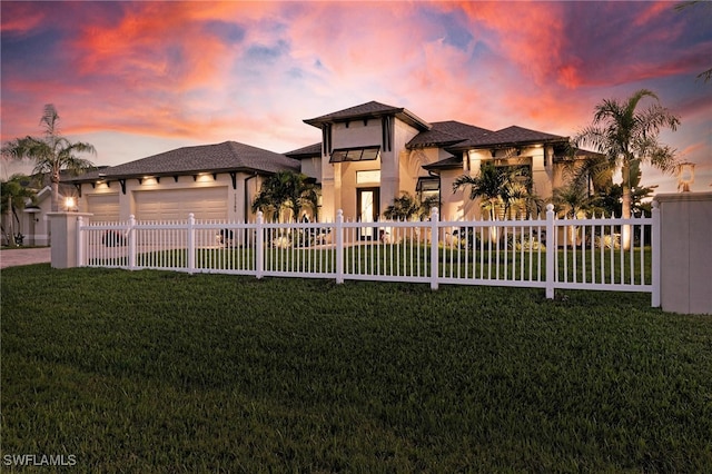 view of front facade featuring a garage and a yard