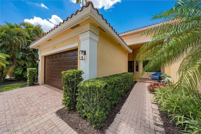 view of side of home with a garage