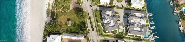 aerial view with a water view and a beach view