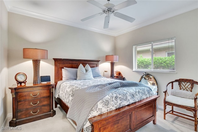 carpeted bedroom with ceiling fan and crown molding