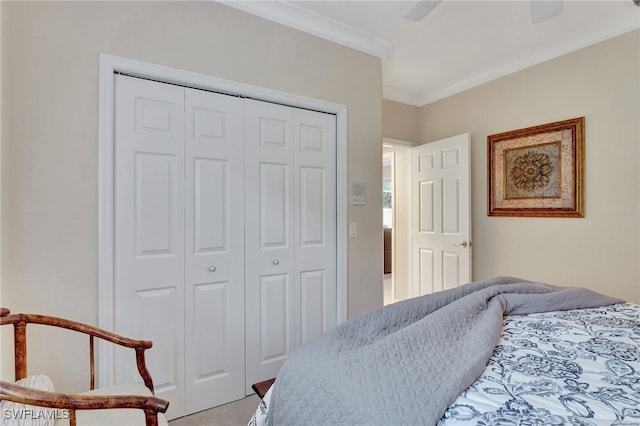 carpeted bedroom with ceiling fan, crown molding, and a closet