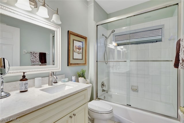 full bathroom with vanity, toilet, and combined bath / shower with glass door