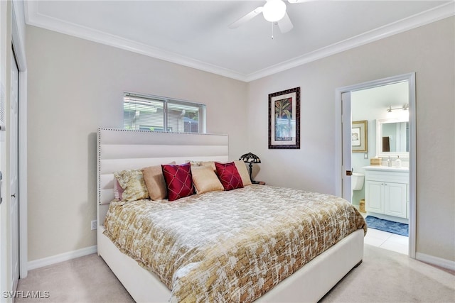 carpeted bedroom with ceiling fan, ornamental molding, and ensuite bath