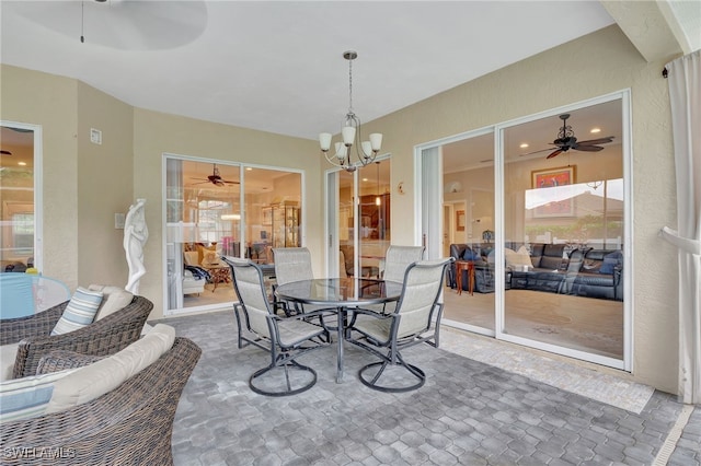 dining room featuring a healthy amount of sunlight and ceiling fan with notable chandelier