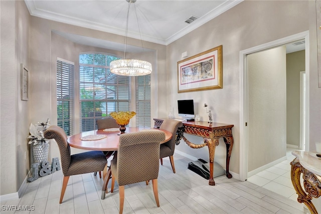 dining space featuring a notable chandelier, ornamental molding, and light tile patterned floors