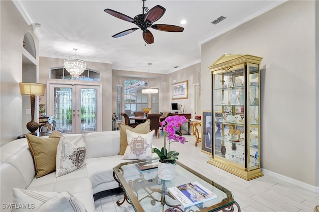 living room with ceiling fan with notable chandelier, ornamental molding, and french doors