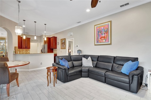 living room featuring ceiling fan and ornamental molding