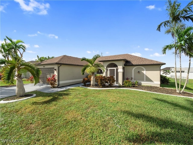 mediterranean / spanish house with a front yard and a garage