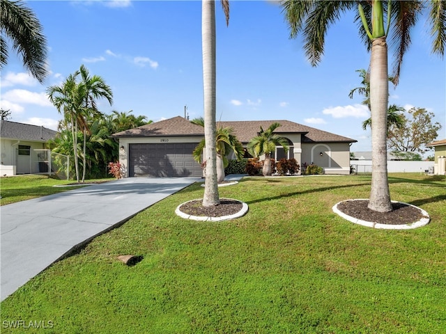 view of front of property with a front yard and a garage