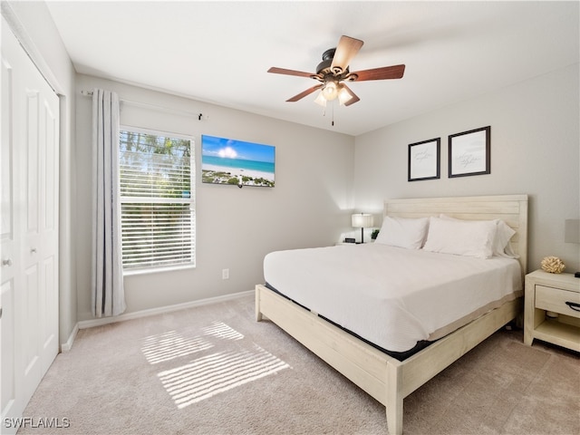 carpeted bedroom with a closet and ceiling fan