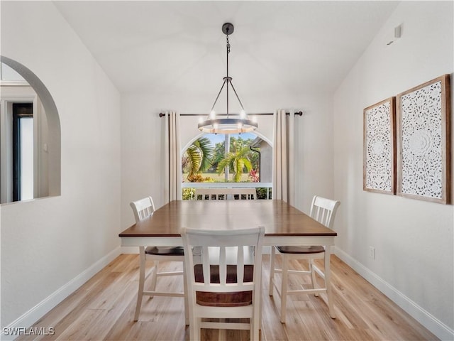 dining area featuring an inviting chandelier and light hardwood / wood-style floors