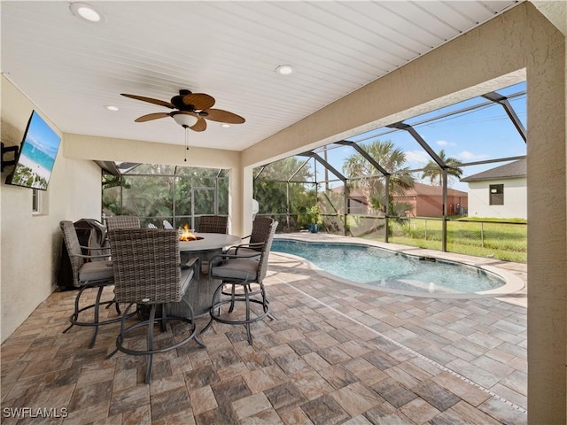 view of swimming pool featuring a lanai, an outdoor fire pit, and a patio