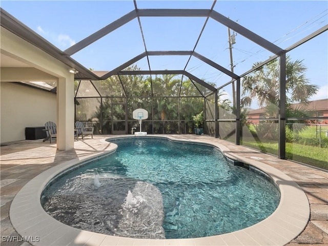 view of pool with a patio area, a lanai, and pool water feature