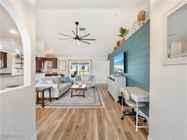 living room with ceiling fan and light wood-type flooring