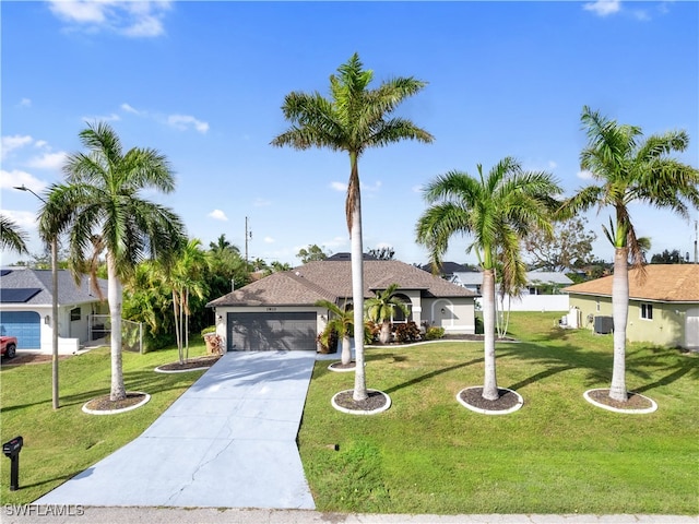 view of front of home featuring a front yard, a garage, and central AC