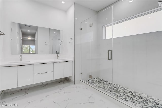 bathroom with vanity, a healthy amount of sunlight, and an enclosed shower