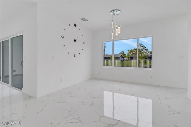 unfurnished room with a chandelier