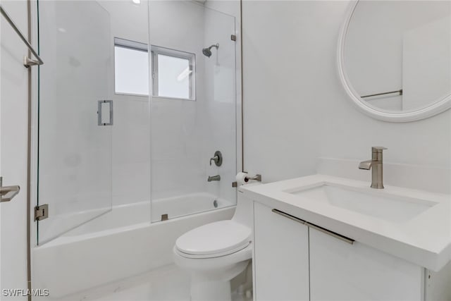 full bathroom with vanity, tiled shower / bath combo, and toilet