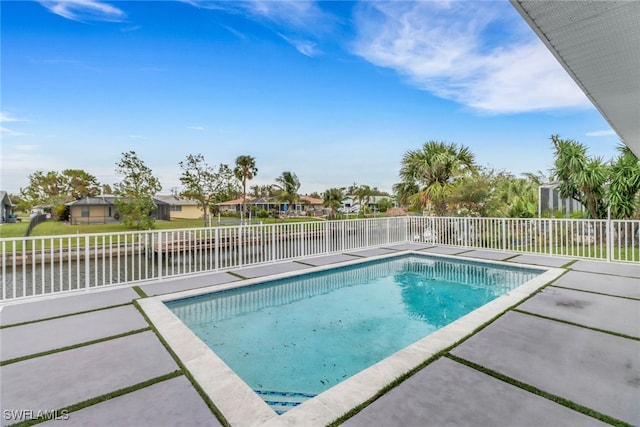 view of pool featuring a patio area and a water view