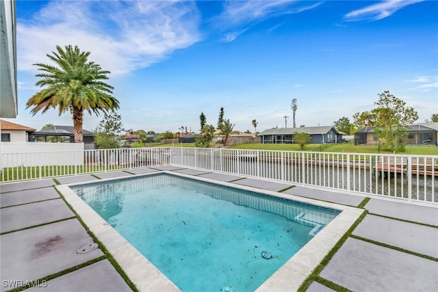 view of pool featuring a patio and a water view