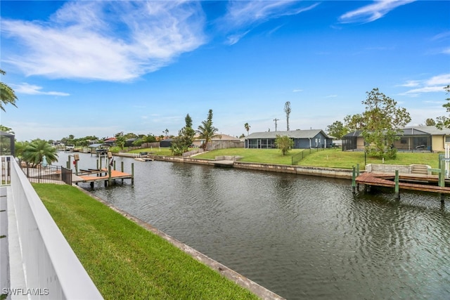 view of dock featuring a water view and a yard