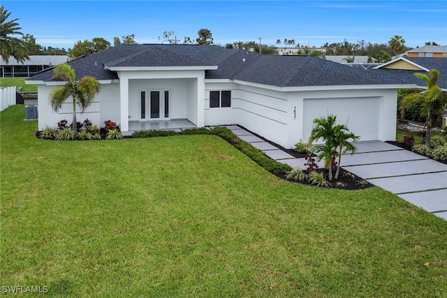 view of front of home with a front lawn, a garage, central air condition unit, and french doors