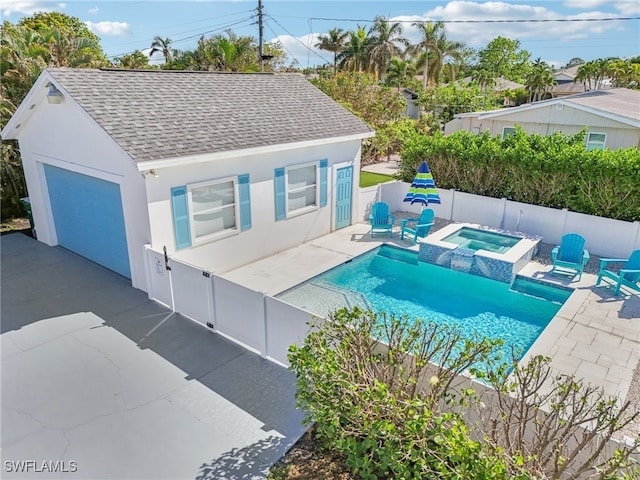 view of swimming pool with a patio and an in ground hot tub