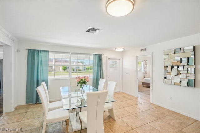 dining space featuring light tile patterned flooring