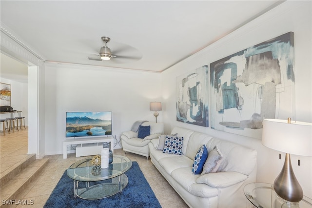 tiled living room featuring ornamental molding and ceiling fan