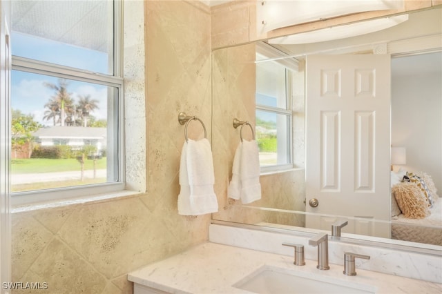 bathroom with vanity and plenty of natural light