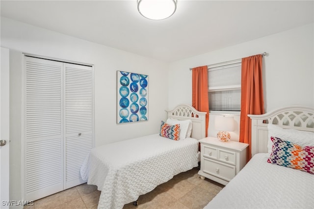 tiled bedroom featuring a closet