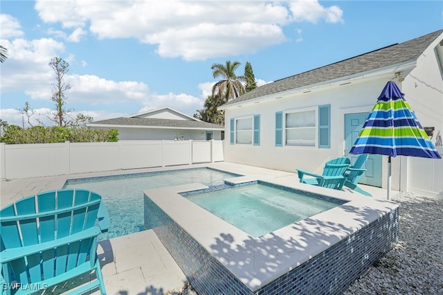 view of swimming pool featuring a patio and an in ground hot tub