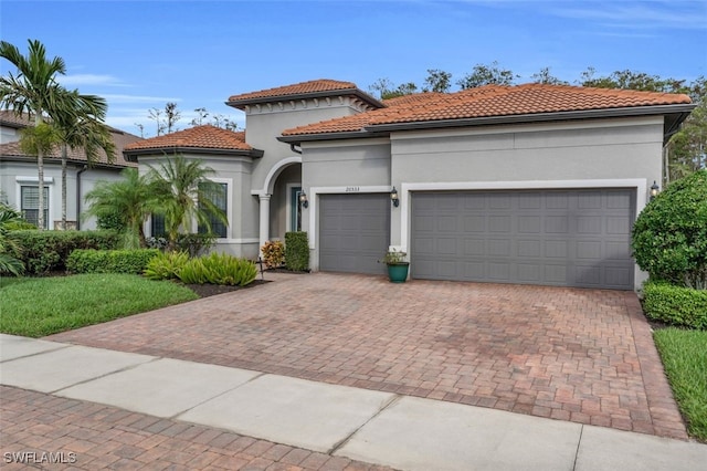 mediterranean / spanish home with a garage