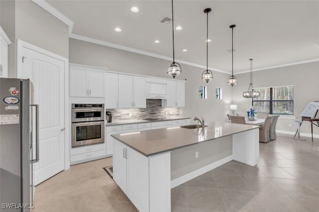 20533 Wilderness Ct, Estero, FL 33928 - kitchen with stainless steel appliances, tasteful backsplash, crown molding, white cabinets, and light tile patterned flooring