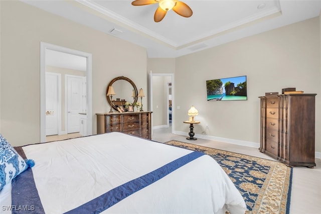 bedroom with a tray ceiling, ceiling fan, and ornamental molding