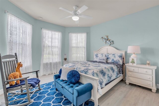 20533 Wilderness Ct, Estero, FL 33928 - bedroom with light wood-style flooring and a ceiling fan