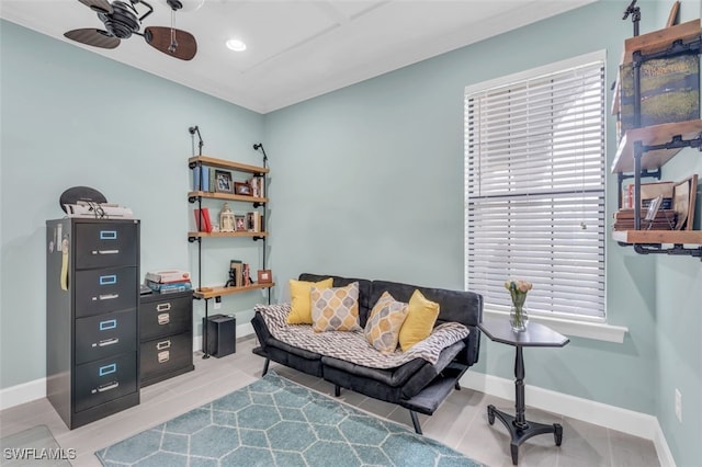 sitting room with tile patterned floors and ceiling fan