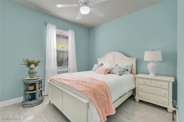 bedroom with light hardwood / wood-style floors and ceiling fan