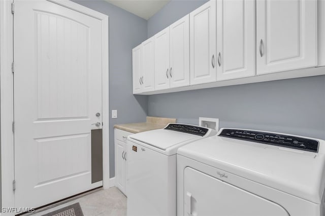 washroom with cabinets and separate washer and dryer