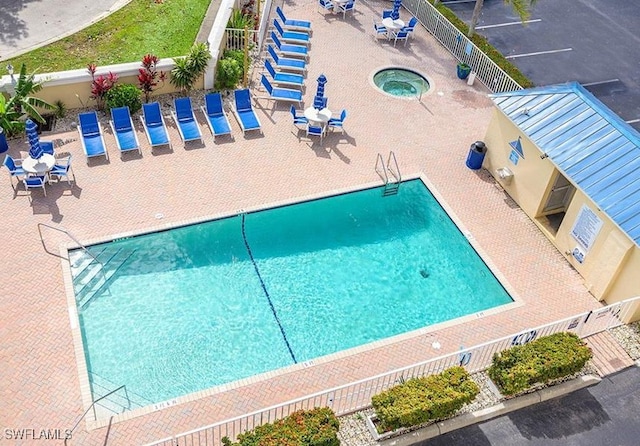 view of swimming pool with a patio and a community hot tub