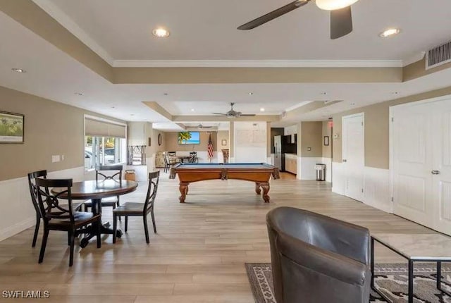 recreation room featuring ornamental molding, billiards, ceiling fan, a raised ceiling, and light hardwood / wood-style flooring