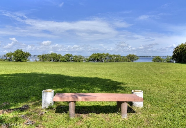 surrounding community featuring a yard and a water view