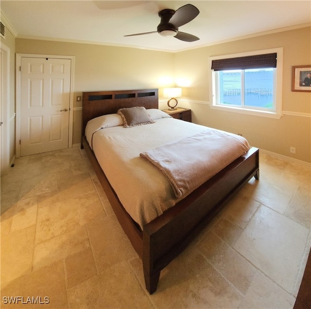 bedroom with ceiling fan and crown molding