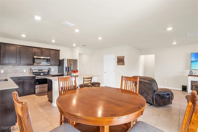 tiled dining space with a fireplace