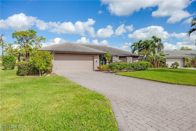 ranch-style home featuring a front lawn and a garage