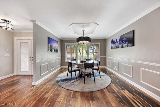 dining room with dark hardwood / wood-style flooring and ornamental molding