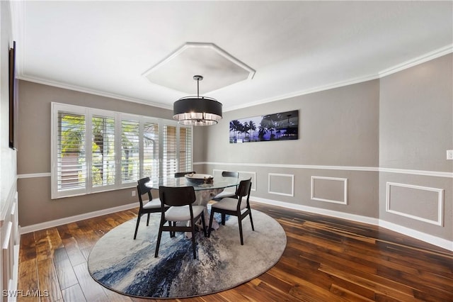 dining space featuring baseboards, dark wood-style flooring, and crown molding