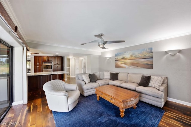 living area with baseboards, a ceiling fan, dark wood finished floors, and crown molding