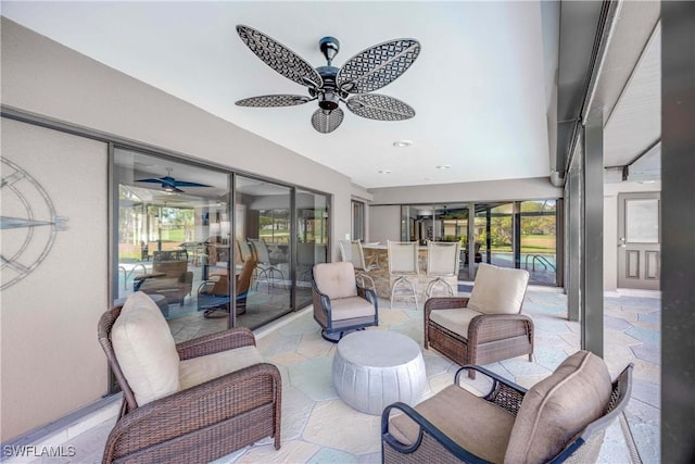 sunroom featuring a ceiling fan