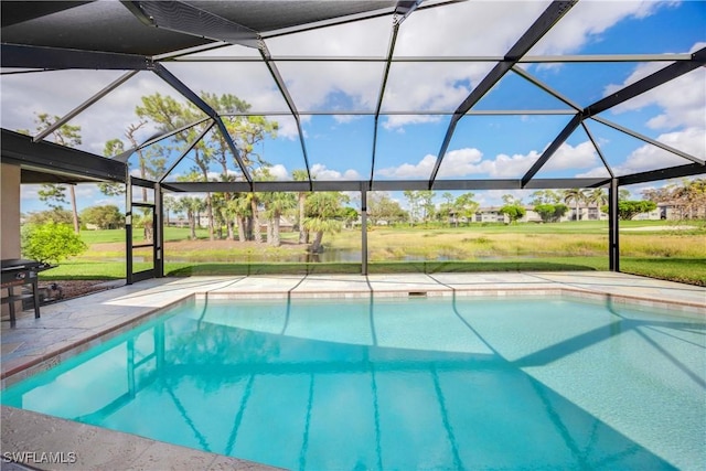 view of pool with a patio area, a lanai, and a lawn